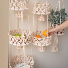 hanging macrame baskets filled with fruit and vegetables are the perfect way to display fruits