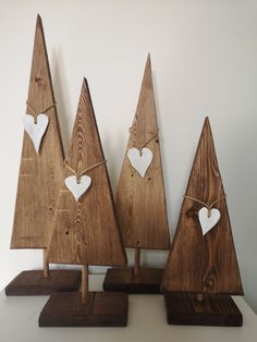 three wooden christmas trees with hearts on them