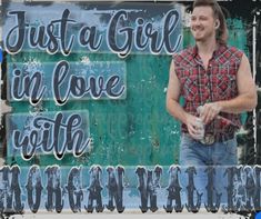 a man standing in front of a green wall with the words just a girl in love with morgan hall