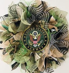 a wreath with the seal of the united states on it and green, white, and black ribbons