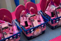 two baskets filled with pink items on top of a table