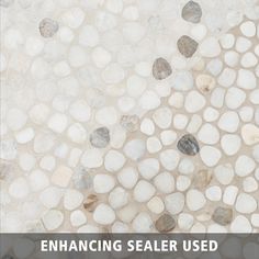 a tile floor with pebbles on it and the words enhancing sealer used