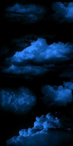 the sky is filled with dark clouds and blue hues on black background, as seen from above