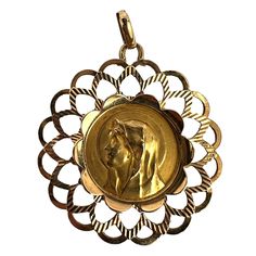 A French 18 karat (18K) yellow gold charm pendant designed as a round medal depicting the Virgin Mary signed Piaget within a frame of polished and ridged gothic arches. Stamped with the eagle's head for French manufacture and 18 karat gold, and maker's mark for Perroud.  Dimensions: 3.4 x 3.1 x 0.22 cm (not including jump ring) Weight: 4.41 grams (Chain not included) Yellow Gold Medallion For Commemoration, Yellow Gold Coin Pendant For Commemoration, Antique Miraculous Medal Round Pendant Jewelry, Antique Jewelry With Miraculous Medal Round Pendant, Round Coin Pendant For Commemoration, Gothic Arches, The Virgin Mary, Eagle Head, Gold Medal