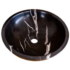 a black marble sink with white streaks on it