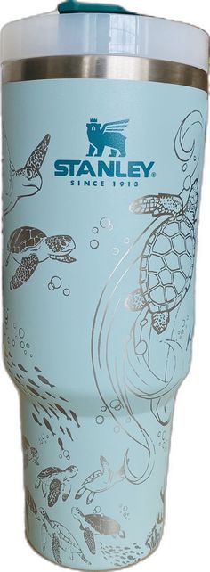 a blue tumbler cup with an image of sea turtles and fish on the side