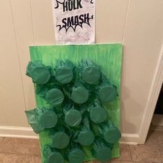 a green bag filled with gummy bears sitting on top of a floor next to a door