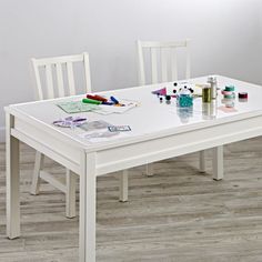 a white table with two chairs next to it