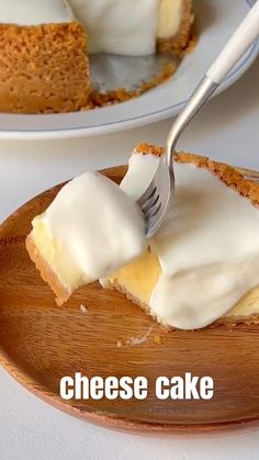 a piece of cheese cake on a wooden plate with a fork in it and the words cheese cake written below