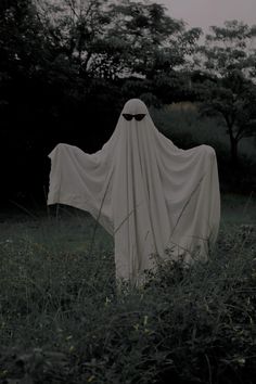 a creepy ghost standing in the middle of a field