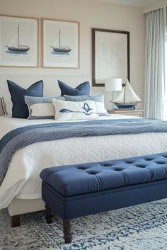 a bedroom with blue and white decor on the walls, along with pictures above the bed