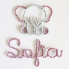 two letters that spell out the word sofiya on a white surface with pink thread