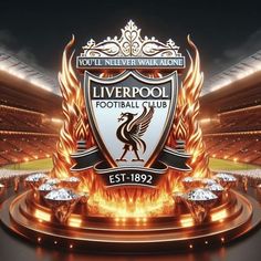 the logo for liverpool football club is shown in front of an arena with fire and flames