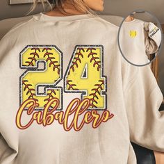 Introducing our custom Softball Gildan Crewneck Sweatshirt, the perfect blend of comfort, style, and team pride! Personalize it with your name and number on the back, along with custom wrist personalization, for a one-of-a-kind look that represents your love for the game. Crafted from a medium-heavy fabric blend of 50% cotton and 50% polyester, this sweatshirt offers a cozy feel that's ideal for the colder months. The classic fit and crew neckline deliver a comfortable wearing experience with a Softball Sweatshirt, Games For Moms, Custom Softball, Softball Shirt, Softball Mom, Game Day Shirts, Custom Sweatshirts, Team Gifts, Polished Look