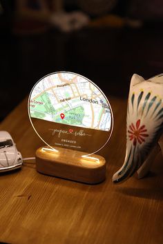 a wooden table topped with a glass plate next to a toy car