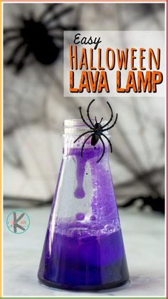 a purple liquid in a glass beakle with a spider on it and the words easy halloween lava lamp