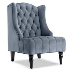 an upholstered blue velvet chair with black legs and tufted backrests