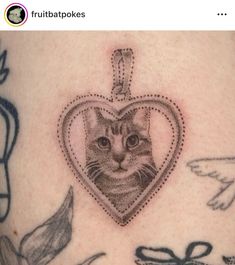 a cat in a heart shaped frame on the side of a woman's stomach