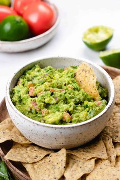 a bowl filled with guacamole surrounded by tortilla chips