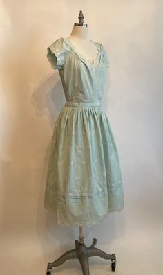 "Rare Clare Potter mint green embroidered floral cotton dress has scalloped sleeves, hem and neckline with a matching belt with a single covered button. Dress zips up in the back and is in excellent vintage condition. The bodice on the dress seems too have been made for someone with a long torso, so please mind the measurements listed below! Shoulders 17\" Chest 38-40\" Waist 28\" Hips 60\" Underarm seam to waist seam 9\" Length from top of shoulder to hem 45\" Vintage garments have been previou Classic Broderie Anglaise Dresses, Elegant Cotton Dress With Scalloped Edges, 1950s Style Tea Length Dresses, Fitted Cotton Dress With Scalloped Edges, Cotton Dresses With Scalloped Edges And Short Sleeves, Classic Cotton Vintage Dress For Spring, Classic Green Cotton Dress, Vintage Broderie Anglaise Dress For Daywear, Vintage Green Dress With Floral Embroidery