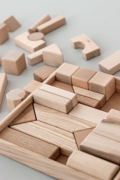 several wooden blocks are arranged in the shape of letters and numbers on a white surface