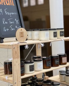 a shelf with jars and candles on it in front of a sign that says special