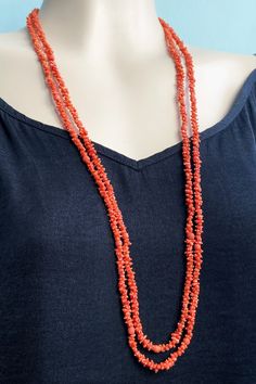 Antique Mediterranean natural coral necklace.  Souvenir of early 1800s tour of Italy.  Small beads intricately hand carved into the shape of pineapples and 'rolling pins' (thought to be ancient Roman fertility symbol).  Here and there along the chain are rounded coral beads.  Antique clasp is rolled gold or pinchbeck type metal.  Very long: 1.65 metres/ 65 inches.   Intense deep orange colour.   The polished beads are approx 5-6mm wide. Weight: 37g Excellent condition for circa 200 years. Clasp Traditional Coral Single Strand Necklace, Traditional Coral Necklace With Gemstone Beads, Traditional Coral Necklace With Polished Beads, Tour Of Italy, Fertility Symbols, Rolling Pins, Deep Orange, Orange Colour, Small Beads