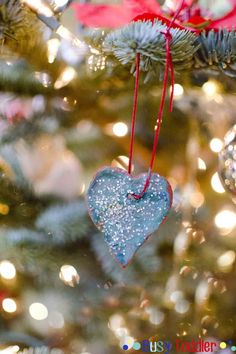 a heart ornament hanging from a christmas tree