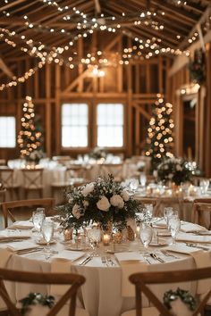 the tables are set with white linens and centerpieces for an elegant wedding reception