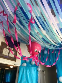 an octopus is hanging from the ceiling with streamers