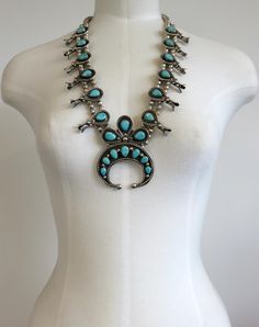 Vintage, Navajo sterling silver squash blossom necklace, set with 22 stunning blue Arizona turquoise cabochons. In excellent vintage condition, lovely patina. Dimensions of Squash: Naja Width 2.6" Naja Height3.6" Length 24" Weight 186 grams Full length with Naja drop - 26.5" Please check out my other designs and vintage pieces here: https://www.etsy.com/uk/shop/YouGotTheSilverUK  Click on customise for any custom queries or bespoke pieces. An original squash blossom necklace is formed with silve Western Blue Jewelry For Western-themed Events, Southwestern Blue Jewelry For Western-themed Events, Blue Concho Jewelry For Western-themed Events, Vintage Blue Turquoise Necklace With Concho, Western Style Blue Turquoise Collectible Necklace, Vintage Turquoise Necklace For Festivals, Silver Squash Blossom Necklace, Turquoise Squash Blossom, Arizona Turquoise