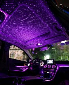 the interior of a car with purple lights