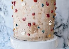 there is a cake that has been decorated with flowers and hearts on the frosting