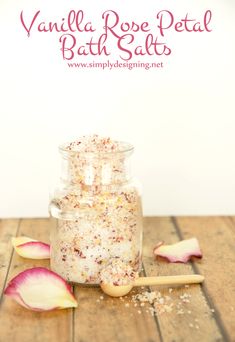 vanilla rose petal bath salts in a glass jar on a wooden table with petals