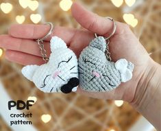 two crocheted keychains in the shape of animals, one is sleeping