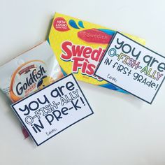 two packets of candy sitting next to each other on top of a white countertop