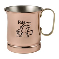 a pink coffee mug with the words pokemon center printed on it and a gold rim