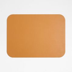 a brown mouse pad sitting on top of a white surface