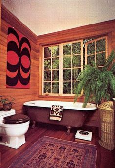 a bathroom with wood paneling and a bathtub in the corner, rug on the floor