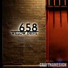 an image of a sign that says 658 willow drive in front of a brick wall