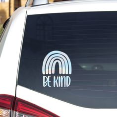 a white car with the word be kind on it's side window sticker