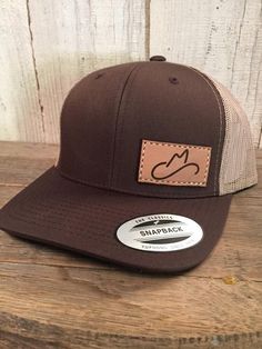 Stand out among the crowd with customization.  Start here to build your own Authentic Leather Patch Hats.We use 100% authentic leather to create each unique patch, then hand stitch them using thick saddle thread in our California warehouse.  Each hat is as unique as its owner.Current production time is 3-4 weeks after proof approval.(Hat color option based on product availability - we will contact you if a purchased item is backordered)Hat Specs- Richardson 112     • SHAPE MidPro     • FABRIC Co Brown Hats With Leather Backing For Outdoor, Outdoor Brown Hats With Leather Backing, Brown Hat With Leather Backing For Outdoor, Outdoor Brown Hat With Leather Backing, Adjustable Leather Snapback Hat In Brown, Adjustable Leather Brown Snapback Hat, Adjustable Brown Leather Snapback Hat, Brown Leather Snapback Hat, Brown Adjustable Hat With Curved Bill