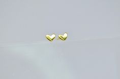 This charming Beautiful Heart Shaped stud made of 925 sterling silver and plated with 18k gold is truly lovable.  Measuring only 0.37cm in height and 0.49cm in width, it is perfect for everyday wear. The intricate design is sure to draw compliments from those around you. The quality craftsmanship ensures that this earring will last for years to come.  This piece is simply breathtaking and will make a beautiful addition to anyone's jewelry collection. Gold Heart Stud Earrings, Gold Heart Studs, Heart Shaped Jewelry, Earrings Heart, Jewelry Minimalist, Heart Stud Earrings, Pretty Rings, Heart Studs, Beautiful Heart