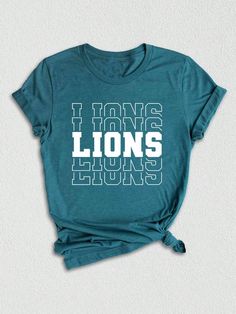 Introducing our latest addition to the winning lineup - the Lions Team Mascot Shirt!  Embrace your fierce school spirit and show off your pride with this Lions-themed tee that perfectly captures the essence of your favorite team. Crafted with utmost care and dedication, this Lions Mascot Shirt is designed to unite fans and players alike.  Its vibrant colors and bold lion mascot print make it a standout choice for all supporters. The striking combination of the team name and the mascot beautifull Gifts For Teammates, Team Spirit Shirts, Lion Mascot, Lions Pride, Mascot Shirt, Team Mascots, Women Crew Socks, Spirit Shirts, Team Shirt