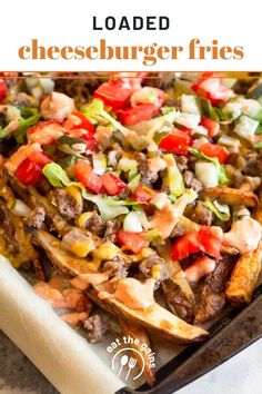 a tray filled with some taco fries covered in cheese and toppings on top