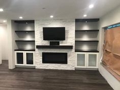 an empty room with built in entertainment center