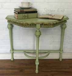 a green table with books and a cup on top