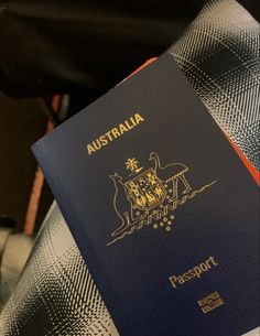 an australian passport sitting on top of a luggage bag