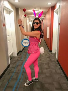 a woman in bunny ears holding a frisbee