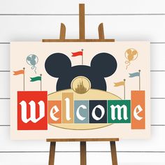 a mickey mouse welcome sign on an easel